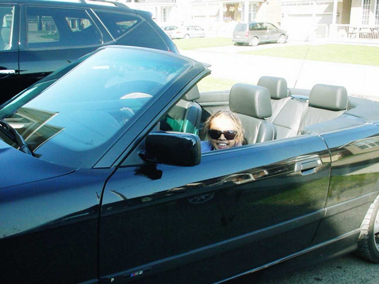 Author’s 8 year old daughter in the driver’s seat of a BMW convertible