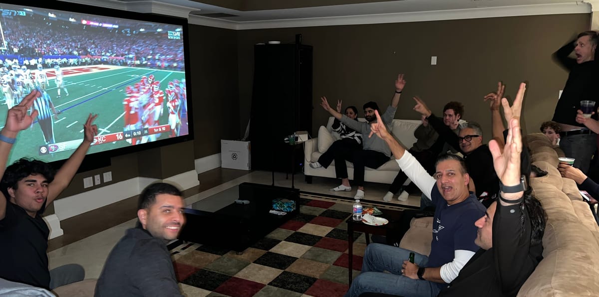 Author’s friends cheering at a Super Bowl party