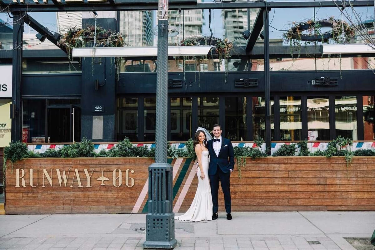 A couple in wedding clothes outside the Runway 06 restaurant in Toronto